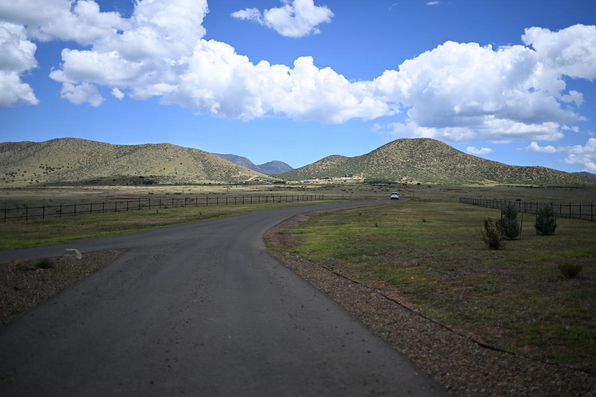 Paved road winding through Ventura Ranch toward the Mingus Mountain foothills